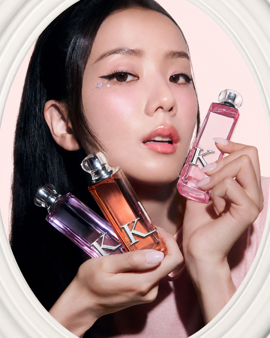 Kissing Light fragrance trio with a model in an oval pink frame